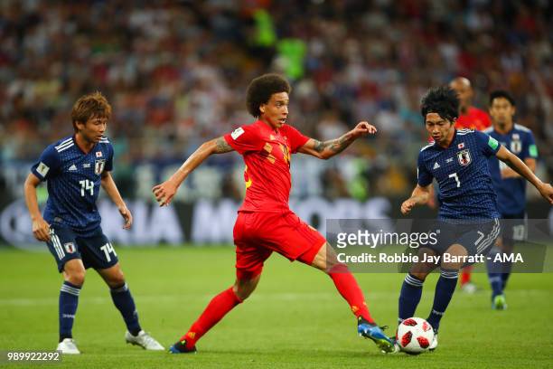 Axel Witsel of Belgium competes with Takashi Inui and Gaku Shibasaki of Japan during the 2018 FIFA World Cup Russia Round of 16 match between Belgium...