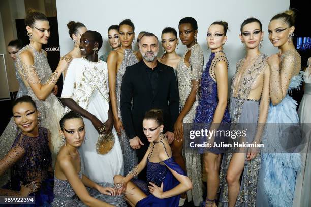 Designer Georges Hobeika poses with models after the final of the Georges Hobeika Haute Couture Fall Winter 2018/2019 show as part of Paris Fashion...