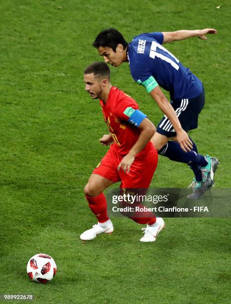 Eden Hazard of Belgium is challenged by Makoto Hasebe of Japan during the 2018 FIFA World Cup Russia Round of 16 match between Belgium and Japan at...