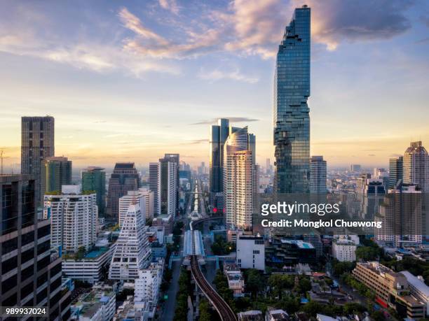 aerial view of bangkok skyline and skyscraper on silom road center of business in capital. modern city and bts skytrain with chao phraya river at bangkok thailand on sunrise - river chao phraya bildbanksfoton och bilder