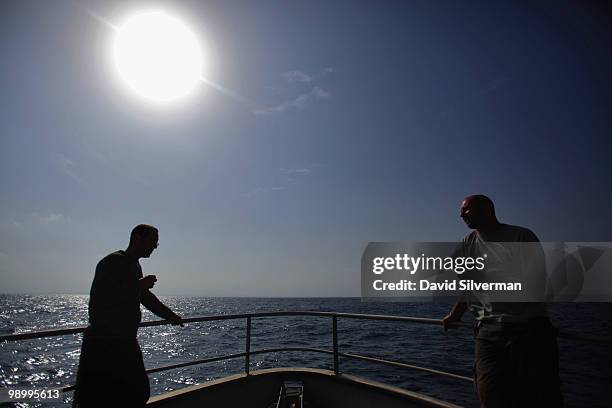 Itai Katzman , captain of EcoOcean's marine research vessel Mediterranean Explorer, and the boat's first mate & engineer Cphir Ashkenazi relax with a...
