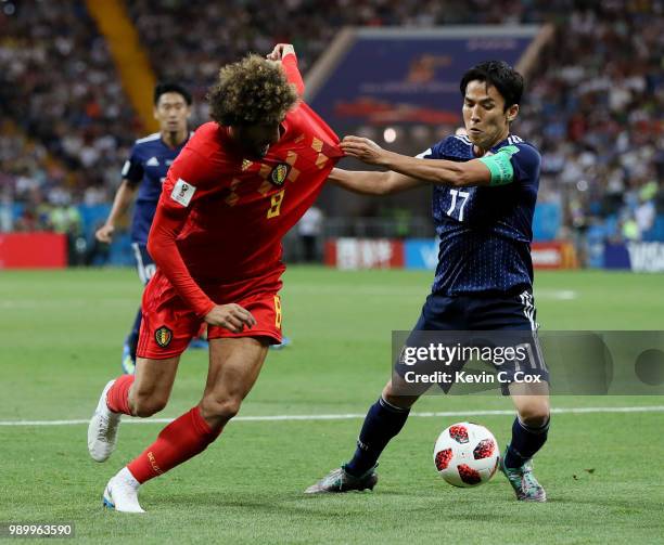 Marouane Fellaini of Belgium is challenged by Makoto Hasebe of Japan during the 2018 FIFA World Cup Russia Round of 16 match between Belgium and...