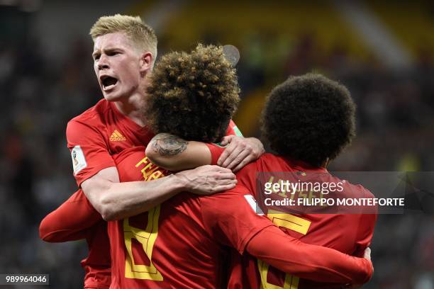 Belgium's midfielder Marouane Fellaini celebrates after scoring the equaliser, with Belgium's midfielder Kevin De Bruyne and Belgium's midfielder...