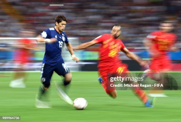 Yuya Osako of Japan is challenged by Nacer Chadli of Belgium during the 2018 FIFA World Cup Russia Round of 16 match between Belgium and Japan at...