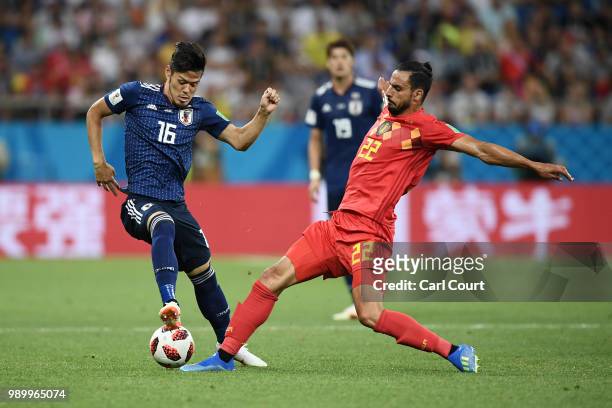 Nacer Chadli of Belgium tackles Hotaru Yamaguchi of Japan during the 2018 FIFA World Cup Russia Round of 16 match between Belgium and Japan at Rostov...
