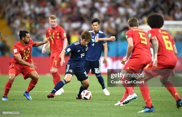 Yuya Osako of Japan is challenged by Nacer Chadli of Belgium during the 2018 FIFA World Cup Russia Round of 16 match between Belgium and Japan at...