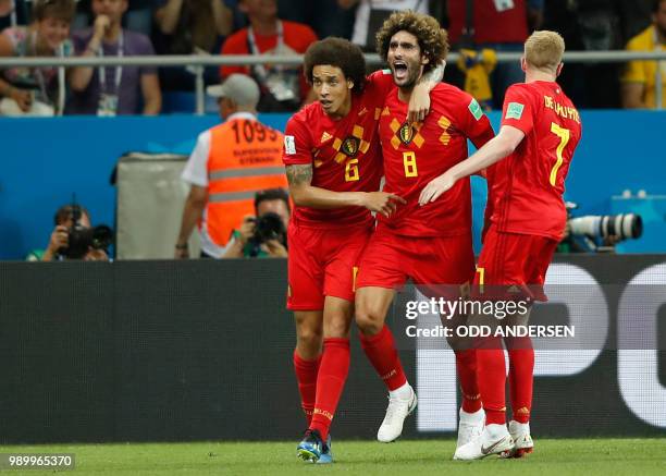 Belgium's midfielder Marouane Fellaini celebrates with teammates Belgium's midfielder Axel Witsel and Belgium's midfielder Kevin De Bruyne after...