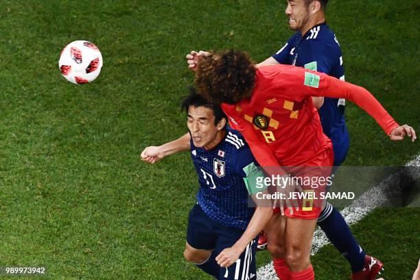 Belgium's midfielder Marouane Fellaini heads the ball past Japan's midfielder Makoto Hasebe to score his team's second goal during the Russia 2018...