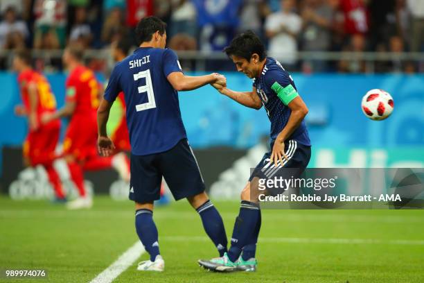 Gen Shoji of Japan helps up Makoto Hasebe of Japan after Marouane Fellaini of Belgium scored a goal to make it 2-2 during the 2018 FIFA World Cup...
