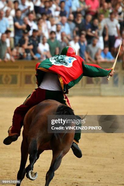 Jockey of the contrada "Drago" Andrea Mari competes with his horse Rocco Nice and wins the historical Italian horse race Palio di Siena on July 2 in...