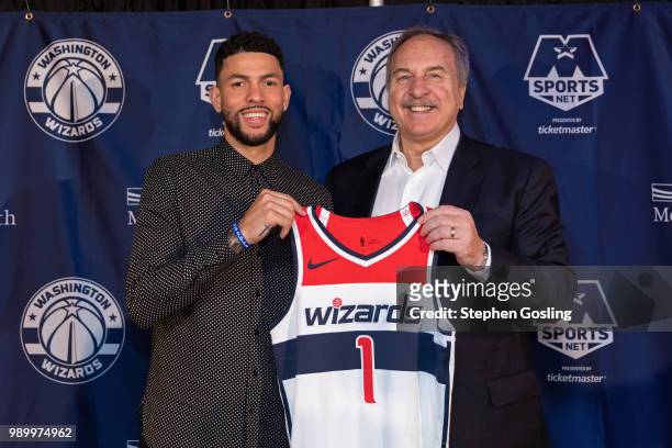 General Manager, Ernie Grunfeld poses for a photo with Austin Rivers of the Washington Wizards during a press conference at Capital One Arena in...