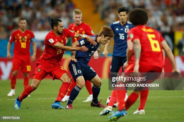 Japan's forward Yuya Osako vies with Belgium's midfielder Nacer Chadli during the Russia 2018 World Cup round of 16 football match between Belgium...