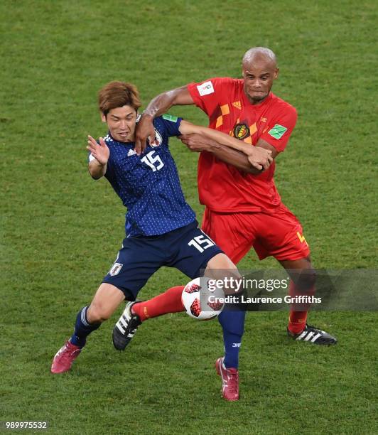 Yuya Osako of Japan is tackled by Vincent Kompany of Belgium during the 2018 FIFA World Cup Russia Round of 16 match between Belgium and Japan at...