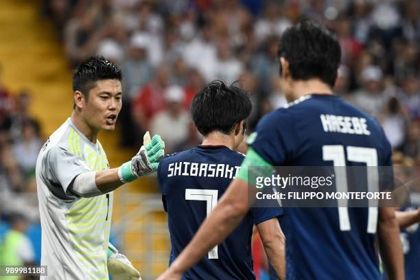 Japan's goalkeeper Eiji Kawashima speaks to Japan's midfielder Gaku Shibasaki during the Russia 2018 World Cup round of 16 football match between...