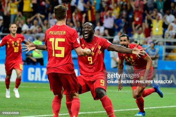 Belgium's forward Romelu Lukaku celebrates with Belgium's defender Thomas Meunier after Belgium's midfielder Nacer Chadli scored his team's third...