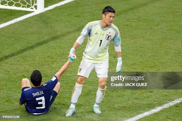 Japan's goalkeeper Eiji Kawashima and Japan's defender Gen Shoji react after Belgium scored their winning goal during the Russia 2018 World Cup round...