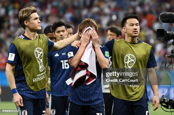 Gotoku Sakai, Takashi Inui and Shinji Okazaki of Japan walks off the pitch dejected folowing the 2018 FIFA World Cup Russia Round of 16 match between...