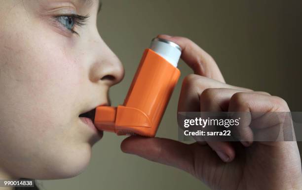 yang girl holding asthma inhaler - inhalation stock pictures, royalty-free photos & images