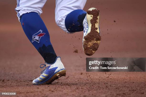 Detailed view of the Adidas cleats worn by Kevin Pillar of the Toronto Blue Jays as he breaks for second base in the second inning during MLB game...