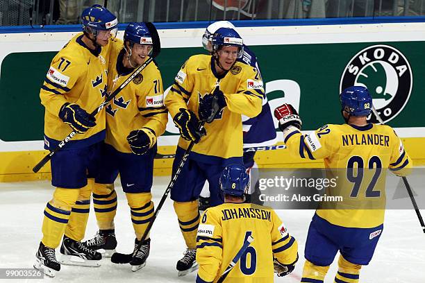 Jonas Andersson of Sweden celebrates his team's second goal with team mates during the IIHF World Championship group C match between Sweden and...