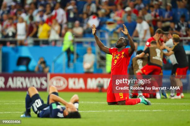 Romelu Lukaku of Belgium reacts as Shinji Kagawa of Japan looks dejected at the end of the 2018 FIFA World Cup Russia Round of 16 match between...