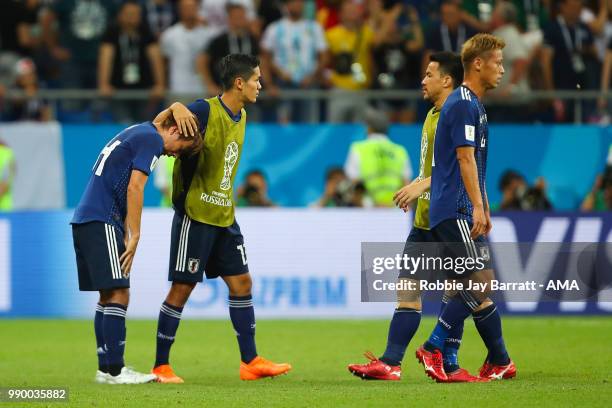 Yoshinori Muto of Japan consoles Takashi Inui of Japan at the end of the 2018 FIFA World Cup Russia Round of 16 match between Belgium and Japan at...