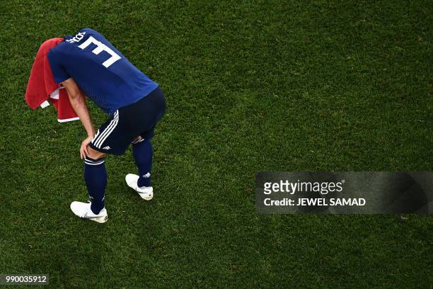 Japan's defender Gen Shoji reacts at the end of the Russia 2018 World Cup round of 16 football match between Belgium and Japan at the Rostov Arena in...