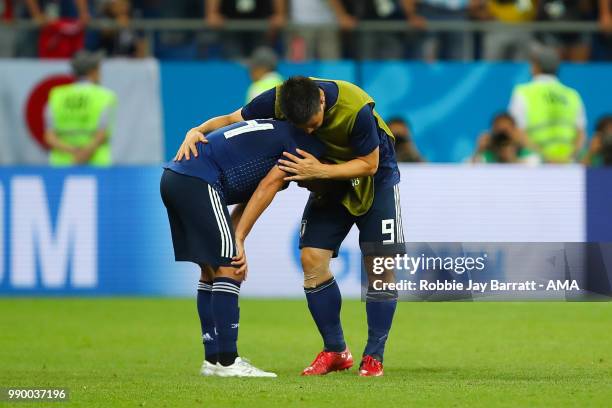 Shinji Okazaki of Japan consoles Takashi Inui of Japan at the end of the 2018 FIFA World Cup Russia Round of 16 match between Belgium and Japan at...