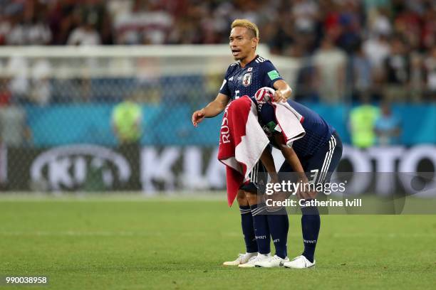 Yuto Nagatomo of Japan and Gen Shoji of Japan look dejected following their sides defeat in the 2018 FIFA World Cup Russia Round of 16 match between...