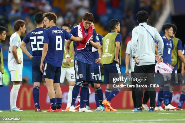 Genki Haraguchi of Japan and Hiroki Sakai of Japan look dejected following their sides defeat in the 2018 FIFA World Cup Russia Round of 16 match...