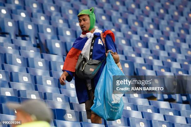 Japan supporter collects rubbish after the Russia 2018 World Cup round of 16 football match between Belgium and Japan at the Rostov Arena in...