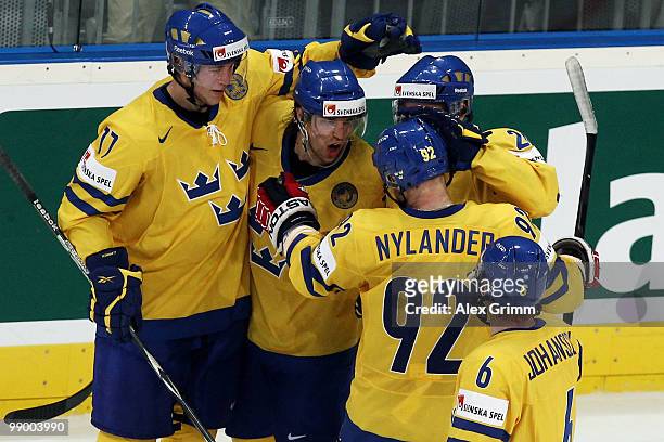 Jonas Andersson of Sweden celebrates his team's second goal with team mates during the IIHF World Championship group C match between Sweden and...