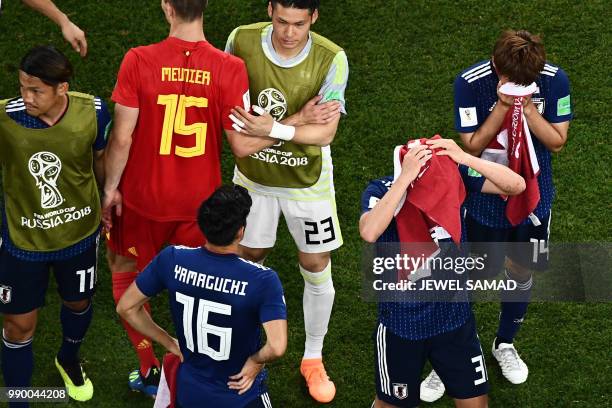 Belgium's defender Thomas Meunier consoles Japan's forward Takashi Usami, Japan's midfielder Hotaru Yamaguchi, Japan's goalkeeper Kosuke Nakamura,...