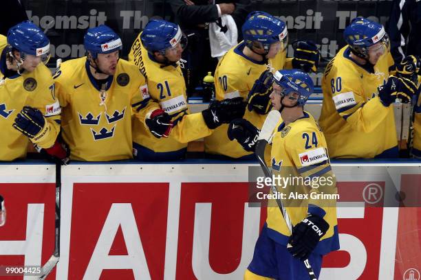 Johan Harju of Sweden celebrates his team's third goal with team mates during the IIHF World Championship group C match between Sweden and France at...