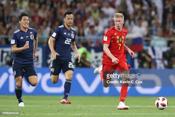 Kevin De Bruyne of Belgium runs with the ball away from Maya Yoshida and Gen Shoji of Japan on the way to Belgium's winning goal during the 2018 FIFA...