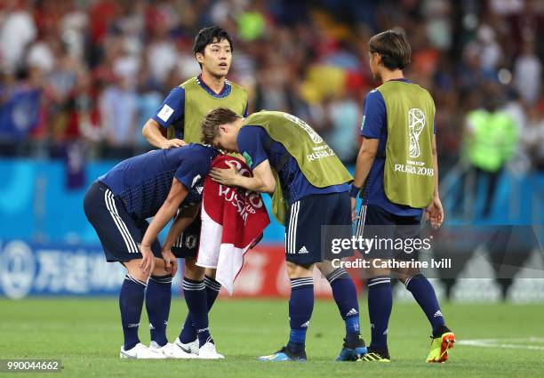 Gotoku Sakai of Japan consoles teammate Gen Shoji following their sides defeat in the 2018 FIFA World Cup Russia Round of 16 match between Belgium...