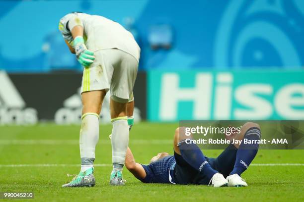 Yuya Osako of Japan is consoled by Eiji Kawashima of Japan during the 2018 FIFA World Cup Russia Round of 16 match between Belgium and Japan at...