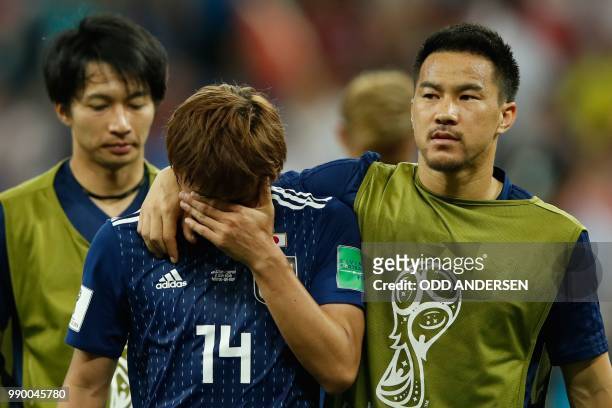Japan's midfielder Takashi Inui and Japan's forward Shinji Okazaki look dejected at the end of the Russia 2018 World Cup round of 16 football match...