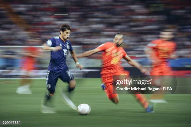 Yuya Osako of Japan is challenged by Nacer Chadli of Belgium during the 2018 FIFA World Cup Russia Round of 16 match between Belgium and Japan at...