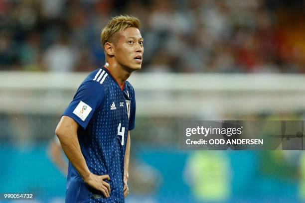 Japan's midfielder Keisuke Honda reacts during the Russia 2018 World Cup round of 16 football match between Belgium and Japan at the Rostov Arena in...