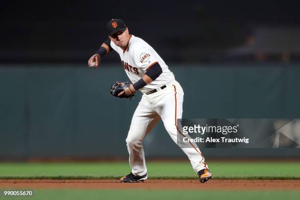 Joe Panik of the San Francisco Giants throws to first base during a game against the Colorado Rockies at AT&T Park on Tuesday, June 26, 2018 in San...