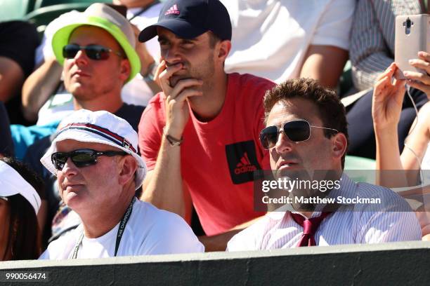 David Macpherson and Justin Gimelstob watch the Men's Singles first round match between Yannick Maden of Germany and John Isner of the United States...