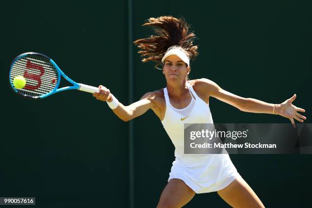 Ajla Tomljanovic of Australia returns to Madison Keys of the United States during their Ladies' Singles first round match on day one of the Wimbledon...