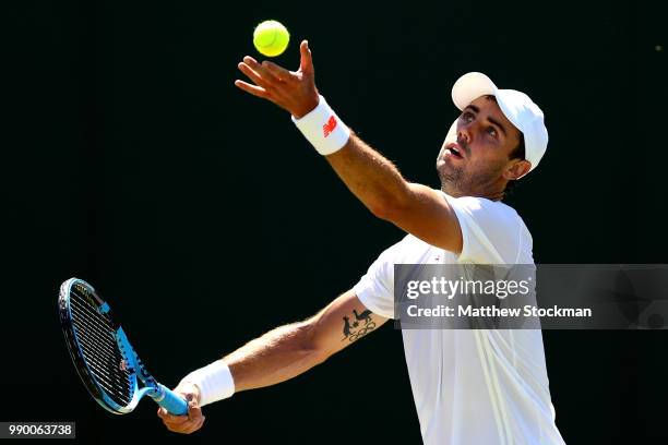 Jordan Thompson of Australia serves in his Men's Singles first round match against Sam Querrey of the United States on day one of the Wimbledon Lawn...