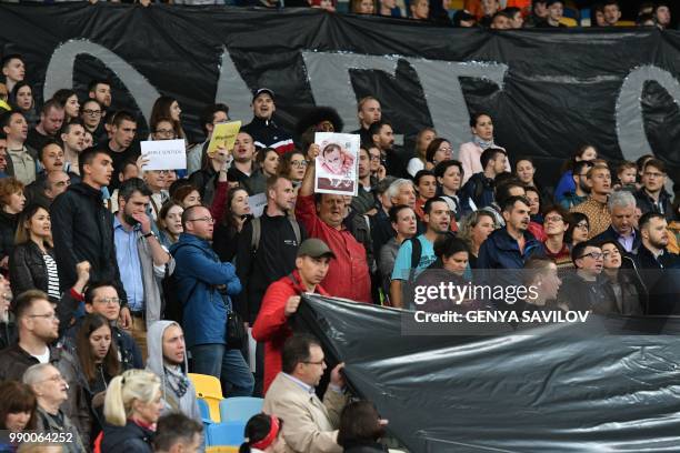 People hold banners reading "Oleg Sentsov, Ukraine with you!" as they attend a meeting at the NSC Olimpiysky stadium in Kiev on July 2 to demand the...