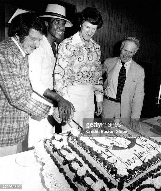 From left, Boston Celtics co-owner Irv Levin, player JoJo White, team captain John Havlicek and Boston Mayor Kevin White cut the cake during a...