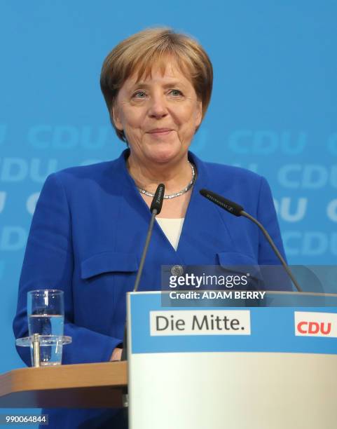 Germany's Federal Chancellor Angela Merkel gives a statement to the press at the German Christian Democrats headquarters in Berlin on July 2, 2018. -...