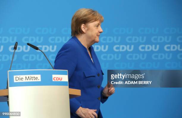 Germany's Federal Chancellor Angela Merkel gives a statement to the press at the German Christian Democrats headquarters in Berlin on July 2, 2018. -...