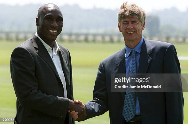 Sol Campbell shakes hands with manager Arsene Wenger during a press conference at Arsenals training ground, London Colney, to announce his signing...