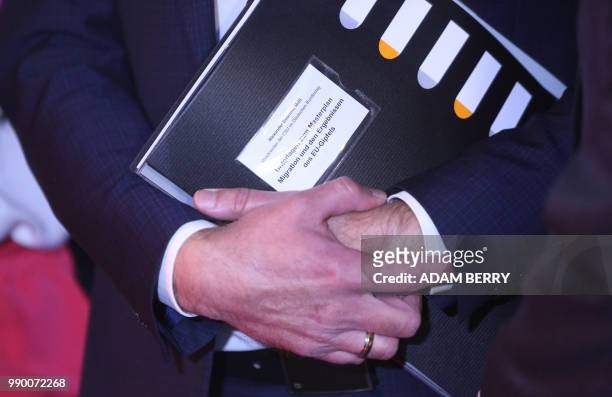 Alexander Dobrindt, first deputy leader of the CDU/CSU group in the Bundestag, carries a folder containing information on the CSU's Masterplan for...